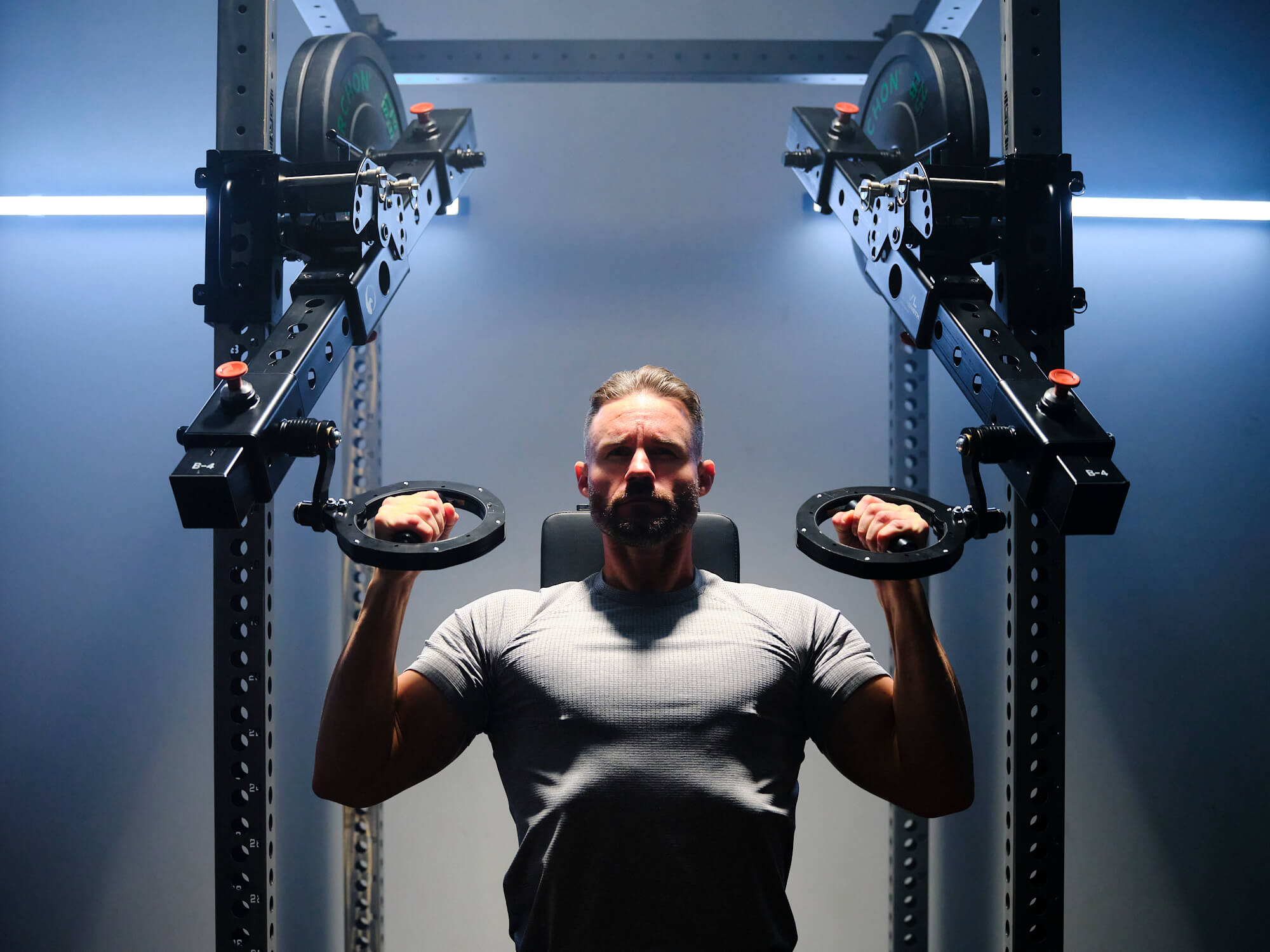 Man exercising with RVL Strength weight lifting device in a gym setting