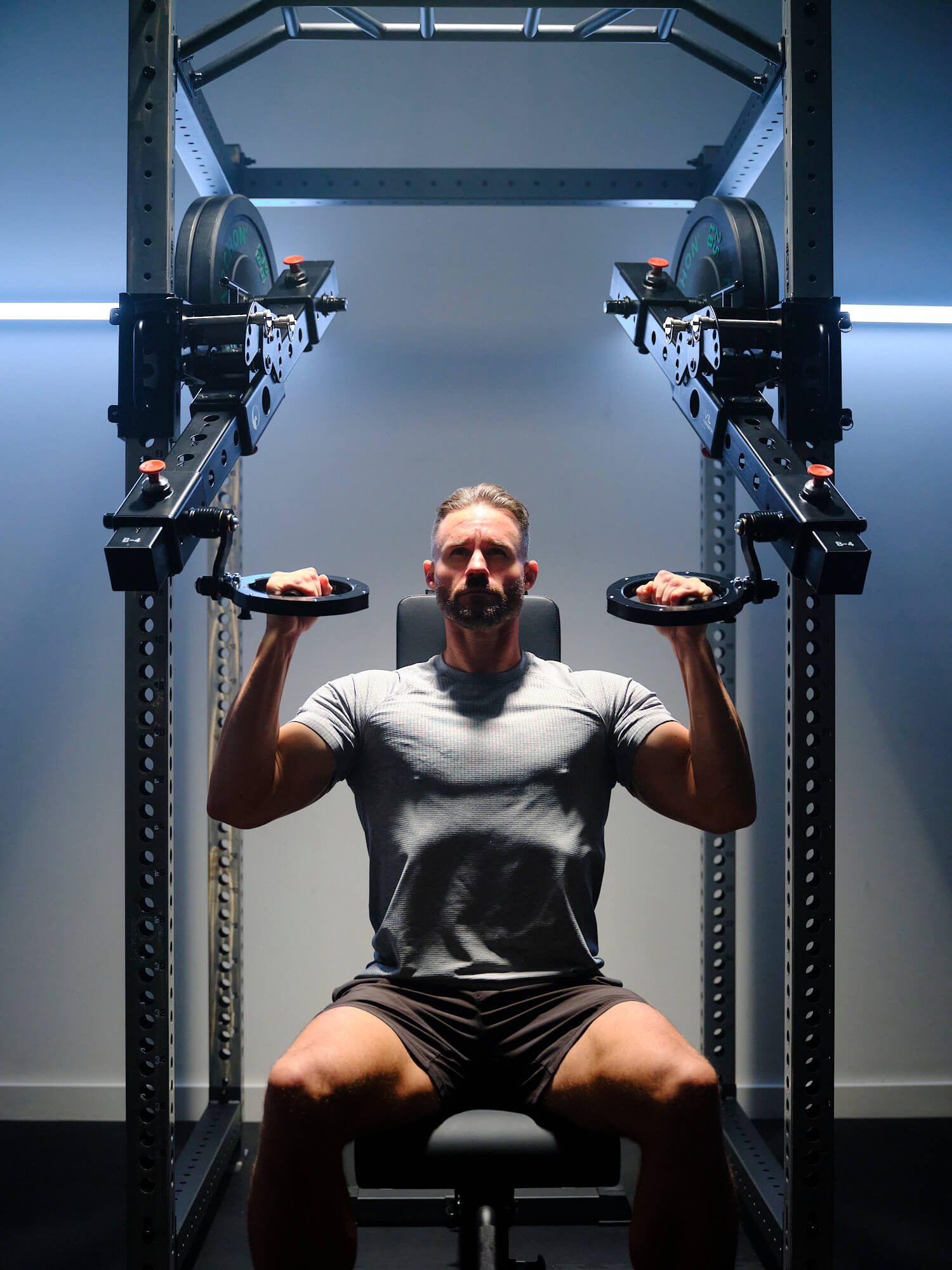 Man performing seated lat pull downs with neutral grip position on RVL Wings 