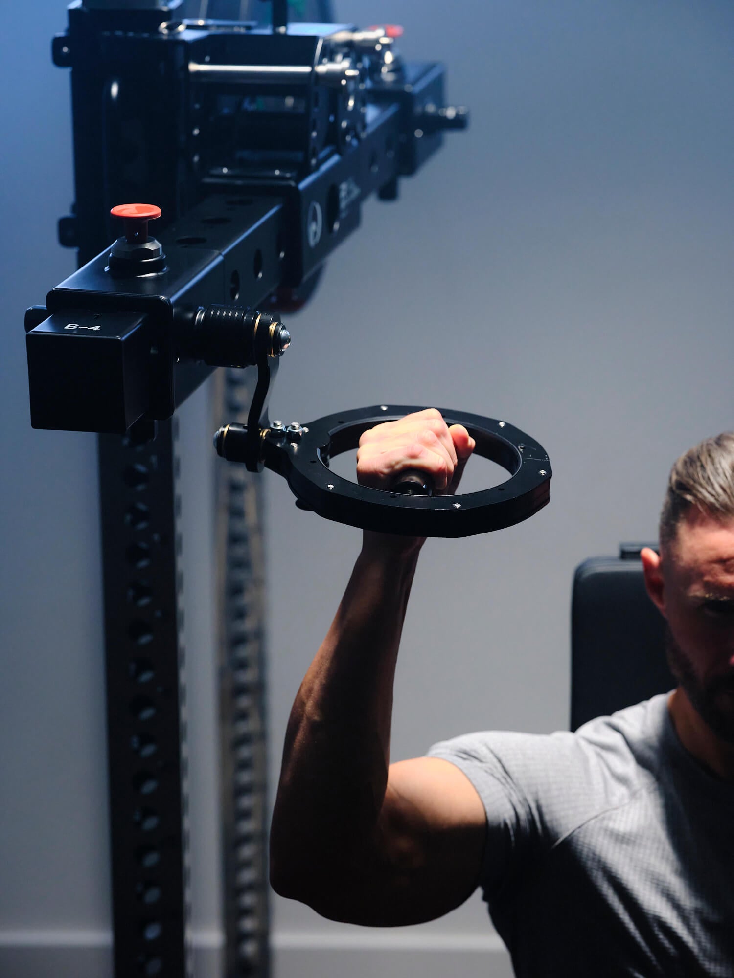 Man doing single-arm pull-downs with RVL Wings. 