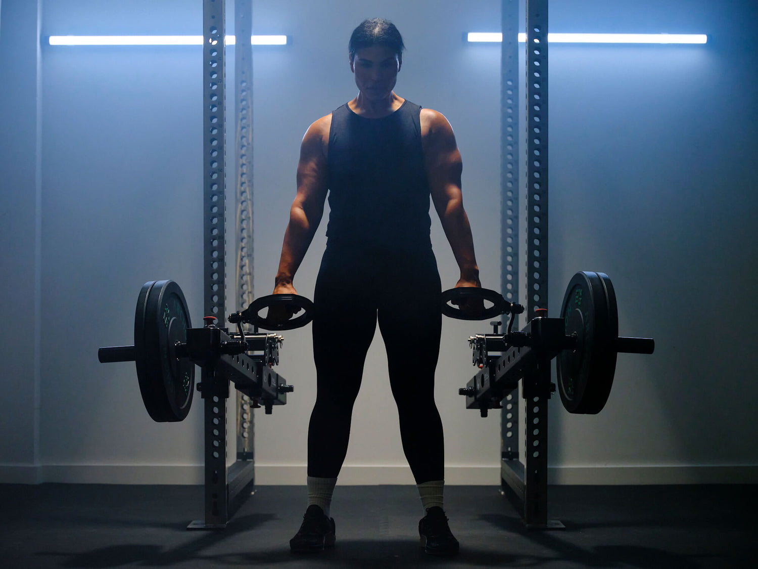 Woman lifting heavy weights with RVL Strength equipment