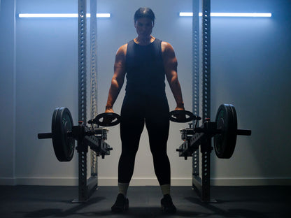 Woman lifting heavy weights with RVL Strength equipment