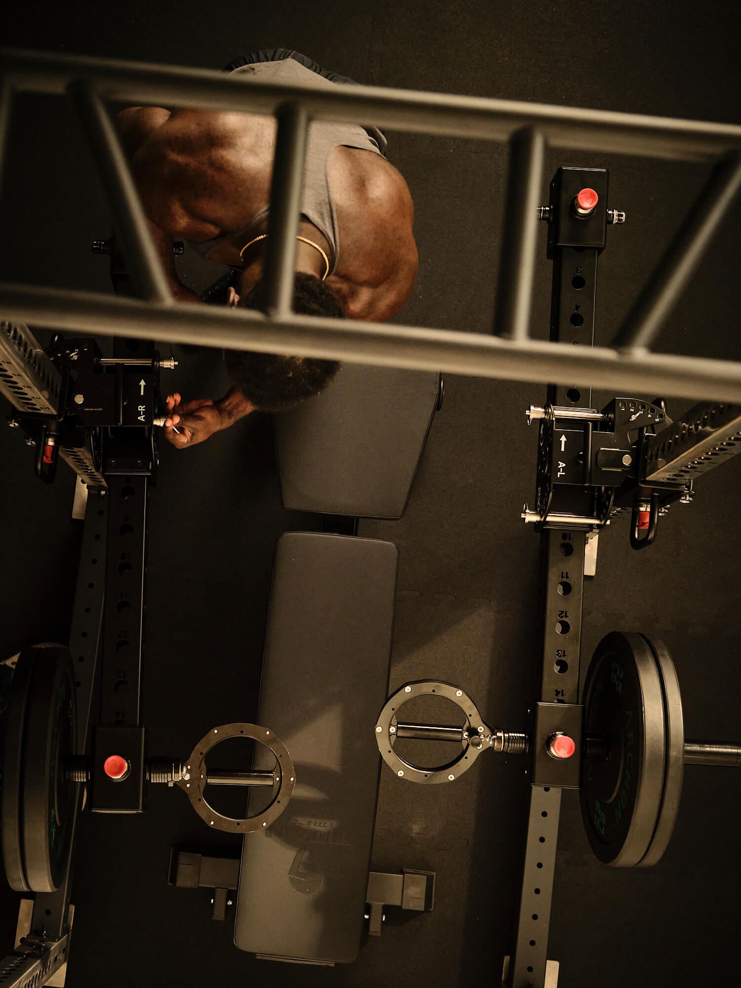 Man working with RVL Strength Wings gym equipment from an overhead perspective. 