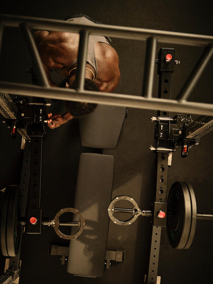 Man working with RVL Strength Wings gym equipment from an overhead perspective. 