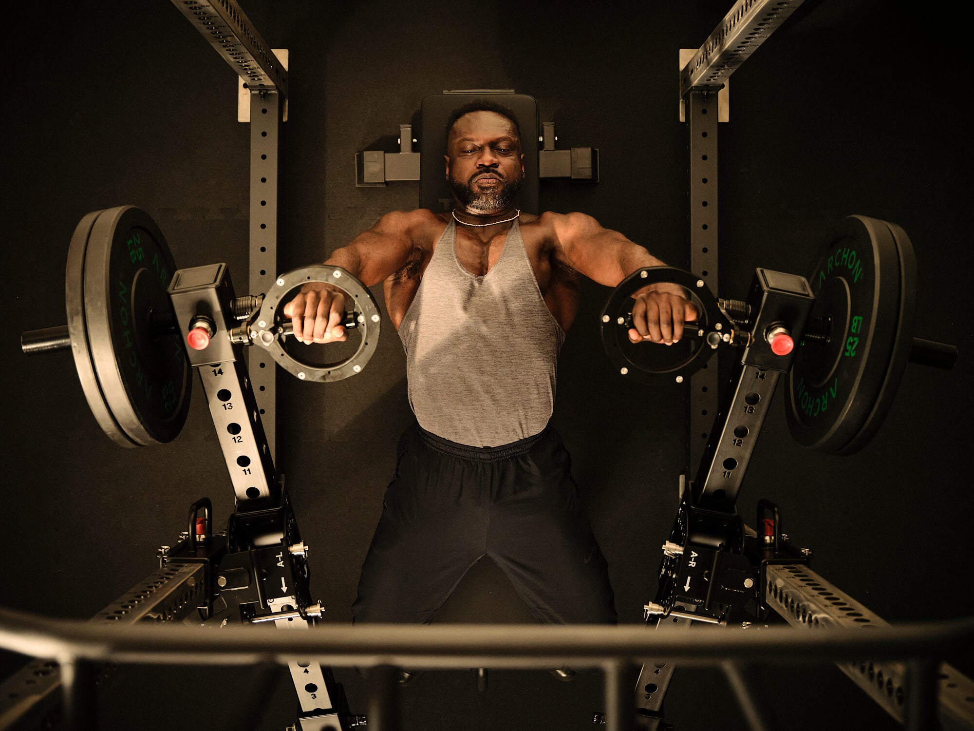 Overhead view of man performing bench press with RVL Wings. 